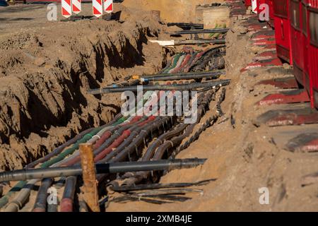 Cavi, tubi, uno accanto all'altro in un cantiere, linee di alimentazione esposte durante i lavori di costruzione, Schadowstrasse a Duesseldorf Foto Stock