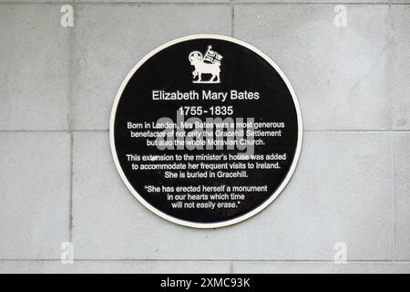 Gracehill, Irlanda del Nord - 26 luglio 2024: L'insediamento storico della Chiesa Morava vince lo status di patrimonio mondiale dell'UNESCO. Cartello che descrive la storia dell'area Foto Stock