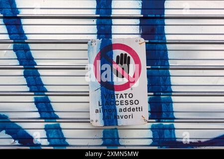 Cartello apposto sull'otturatore di un cantiere con scritto "accesso limitato per personale non autorizzato" Foto Stock
