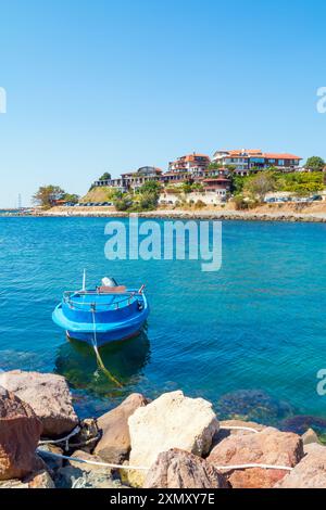 Barche ormeggiate in mare a Nessebar, Bulgaria. Paesaggio estivo soleggiato con barca ormeggiata nei boschi al molo dal cielo blu. Spiaggia pubblica. Foto Stock