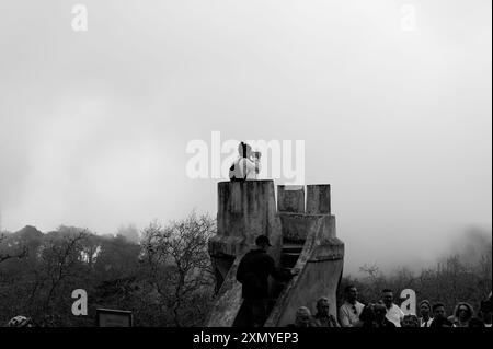 Una fotografa si trova in una piccola torre di guardia a Palazzo pena, catturando le vedute nebbiose che avvolgono l'antico sito Foto Stock