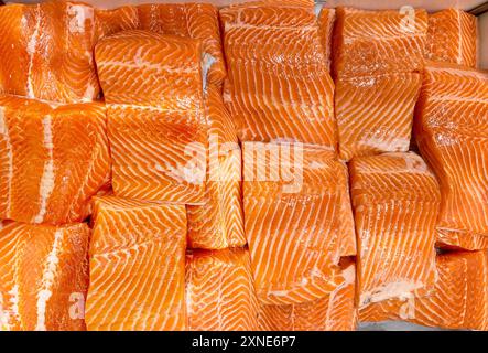 Vista dall'alto del filetto di salmone crudo fresco esposto sul mercato bagnato. Foto Stock