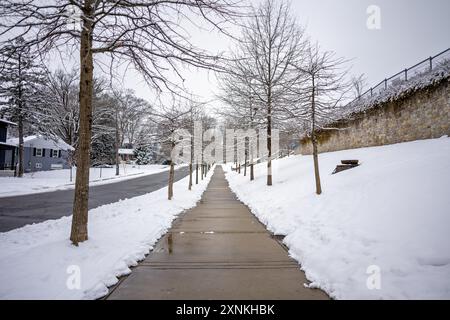 ARLINGTON, Virginia, Stati Uniti — Una scena invernale innevata ad Arlington, Virginia, con la strada e il marciapiede arati. Foto Stock