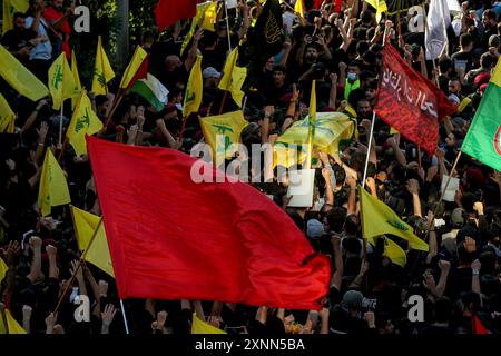 Beirut, Libano. 1 agosto 2024. La gente ondate bandiere durante il servizio funebre del comandante di Hezbollah Fuad Shukr nella periferia meridionale di Beirut. Shukr è stato ucciso in uno sciopero israeliano che ha anche causato la morte di cinque civili e decine di feriti. Crediti: Marwan Naamani/dpa/Alamy Live News Foto Stock
