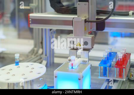 sistema automatizzato progettato per la manipolazione di provette in laboratorio, che illustra l'integrazione della robotica nella ricerca scientifica e medica. Foto Stock