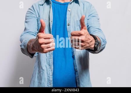 Persona mani con i pollici su fare ok, primo piano di mani dell'uomo fare i pollici su, persone con i pollici su sfondo isolato Foto Stock