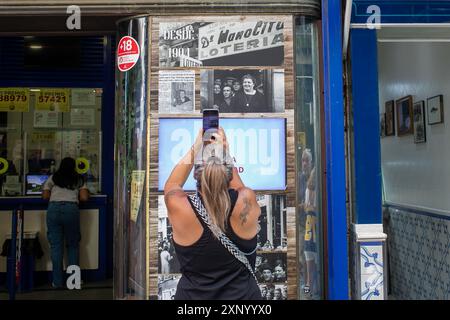 Madrid, Spagna. 2 agosto 2024. Una donna scatta una fotografia di un cartello all'ufficio della lotteria Doña Manolita di Madrid. Molti turisti approfittano delle vacanze estive per acquistare i biglietti della lotteria di Natale presso la tradizionale amministrazione Madrid della lotteria di Doña Manolita in Calle Carmen nel centro di Madrid. (Foto di David Canales/SOPA Images/Sipa USA) credito: SIPA USA/Alamy Live News Foto Stock