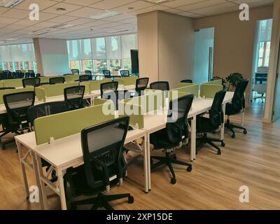 Spazio di lavoro vuoto in un ufficio moderno con un piccolo armadio verde che separa la scrivania. design moderno degli interni dell'ufficio. Foto Stock