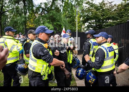 Manchester, 3 agosto 2024. Un uomo è detenuto durante le proteste di estrema destra a Manchester. La dimostrazione arriva quando altre 30 città del Regno Unito affrontano proteste simili, tra cui Liverpool, Bristol, Hull e molte altre. Crediti: Benjamin Wareing/Alamy Live News Foto Stock