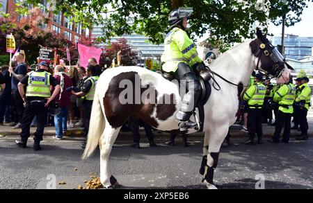 Manchester, Regno Unito, 3 agosto 2024. L'agente di polizia a cavallo aspetta di essere chiamato, come in seguito. Gli agenti di polizia si insinuano e controllano la contro-protesta: La dimostrazione "lotta contro il razzismo”. Gli agenti della polizia di Greater Manchester devono far fronte alla pressione delle proteste di destra e antirazziste, Piccadilly Gardens, nel centro di Manchester, nel Regno Unito, sulla scia del fatale pugnalamento di tre ragazze a Southport e delle violente rivolte che ne sono seguite. Proteste simili si stanno svolgendo in tutto il Regno Unito. Crediti: Terry Waller/Alamy Live News Foto Stock