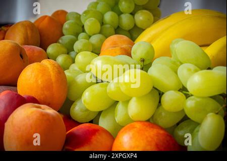 albicocche, pesche, uva e banane, frutta fresca, colorata e sana Foto Stock