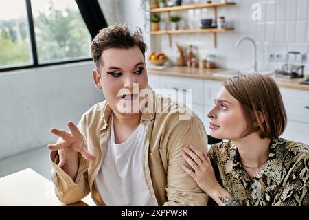 Due amici si impegnano in una conversazione vivace a casa, piena di gioia e connessione. Foto Stock