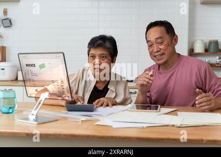 Gravi caucasici anziani anziani coppia di anziani nonni famiglia contare i fondi sulla calcolatrice, fare documenti, risparmiare, pagare bollette domestiche, mortgag Foto Stock