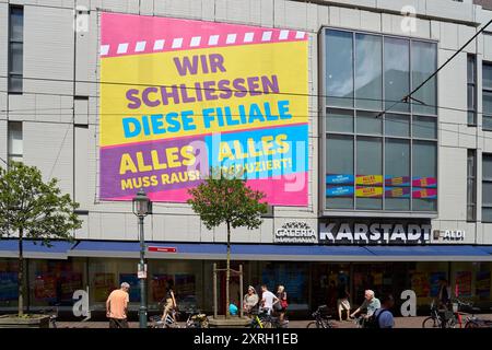 Augusta, Baviera, Germania - 10 agosto 2024: Il negozio Karstadt di Augusta pubblicizza vendite e sconti prima della sua imminente chiusura a causa dell'insolvenza della Galeria Kaufhof, con striscioni accattivanti che annunciano la vendita di liquidazione *** Karstadt-Filiale ad Augusta wirbt mit Schlussverkauf und Rabatten vor ihrer bevorstehenden Schließung aufgrund der Insolvenz von Galeria Kaufhof, mit auffälligen Bannern, die den Räumungsverkauf ankündigen Foto Stock