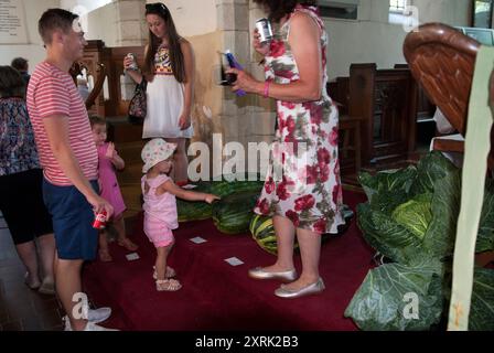 Village Show Regno Unito. Le verdure fatte in casa più grandi e pesanti sono esposte nella chiesa dei villaggi di San Pietro e San Paolo. Famiglia, genitori e bambini piccoli, agosto festivi lunedì. Cudham Village Summer Fete Kent Inghilterra anni 2010 2017 HOMER SYKES Foto Stock