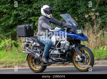 Potterspury, Northants, Regno Unito - 11 agosto 2024: 2019 BMW R 1250 GS ADVENTURE RALLYE te moto blu che viaggia su una strada inglese Foto Stock