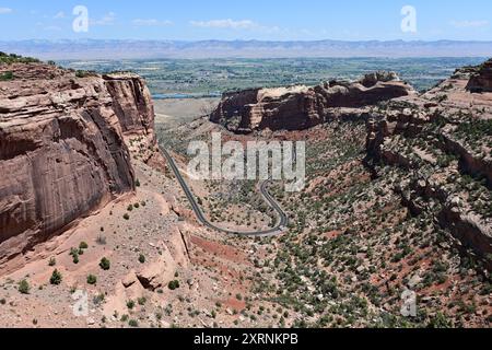 Vista panoramica del Colorado National Monument nelle giornate estive limpide e soleggiate con la città di Fruita, Colorado visibile sullo sfondo. Foto Stock