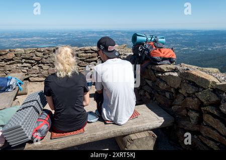 Giovani coppie di escursionisti che riposano sulla cima del monte Sniezka in Polonia Foto Stock