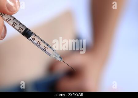 Siringa per insulina. Una donna con una siringa sta per iniettarsi insulina. Trattamento del diabete. Medicina e concetto di salute. Iniziatevi con Foto Stock