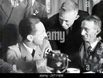 Una fotografia mostra il ministro del Reich, il dottor Joseph Goebbels, impegnato in una conversazione con un lavoratore a un festival del lavoro. L'immagine cattura gli sforzi propagandistici del regime nazista per promuovere l'unità e la cameratismo tra i funzionari governativi e la classe operaia. Goebbels, in qualità di ministro della Propaganda, fu determinante nella creazione di immagini che ritraevano il governo nazista come strettamente collegato e sostenitore del popolo tedesco. Foto Stock