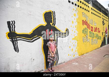 Reazioni alle dimissioni di Sheikh Hasina Wajed a Dhaka, Bangladesh, Uno studente dipinge un nuovo graffito su un muro di strada nel campus dell'Università di Dhaka a Dhaka, Bangladesh, 13 agosto 2024. In un discorso alla nazione, il 5 agosto 2024 il capo di stato maggiore dell'esercito generale Waker-Uz-Zaman ha annunciato le dimissioni del primo ministro Sheikh Hasina dopo settimane di disordini. Il premio Nobel Muhammad Yunus ha prestato giuramento come capo del governo ad interim del Bangladesh l'8 agosto 2024 dopo che lo sceicco Hasina si è dimesso e ha lasciato il paese in mezzo a violente proteste sul sistema di quote di lavoro del governo. Dhaka Distretto di Dhaka Bangladesh Co Foto Stock