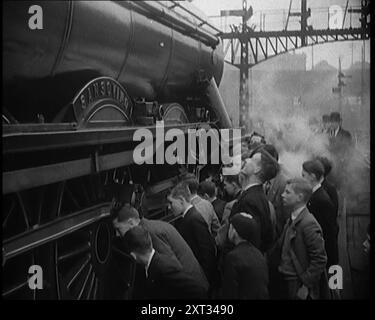 Ragazzi che fissano una locomotiva a vapore, 1931. Hai mai preso i numeri dei motori? Hai mai provato l'emozione di ritrovarti su un treno così crack come The Flying Scotsman?" Locomotiva A3 n. 60053 "Sansovino". Da Time to Remember - A New era, 1931 (Reel 3); documentario sul mondo nei primi anni '1930 Foto Stock