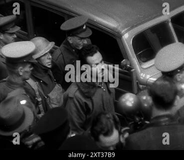 Un pilota italiano catturato scortato attraverso una stazione ferroviaria, 1940. La Gran Bretagna durante la seconda guerra mondiale. "Una volta e una volta solo il Duce [Mussolini] chiese ai suoi alleati [cioè i tedeschi] di permettere agli italiani di prendere parte all'attacco aereo contro la Gran Bretagna. Una sola volta, perché era un'occasione costosa per lui sia nelle macchine che negli uomini. Da Time to Remember - Standing Alone, 1940 (Reel 3); film documentario sugli eventi dei mesi successivi del 1940. Foto Stock