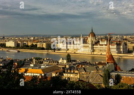 Budapest Ungheria. Vista della capitale europea. Le navi da crociera passano sul Danubio. Il Parlamento imponente sullo sfondo. La br Foto Stock