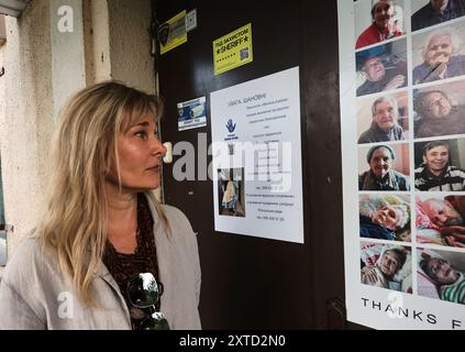 CHARKIV, UCRAINA - 13 AGOSTO 2024 - attraverso la presidenza della ONG di guerra Olha Kleitman mostra le foto della residente del rifugio Big Family che si prende cura delle persone anziane single lasciate senza casa dalla guerra ed è gestita dalla sua organizzazione, Kharkiv, Ucraina nord-orientale. Foto Stock