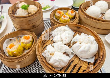 Guardando in basso il dim sum in cesti a vapore su un tavolo in un ristorante a George Town, Penang, Malesia. Foto Stock