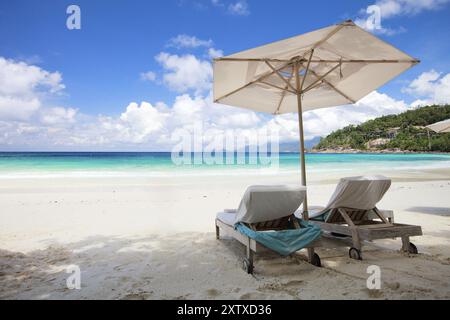 Due sdraio e un ombrellone sulla spiaggia di la Digue, Seychelles, la Digue, Oceano Indiano, Seychelles, Africa Foto Stock