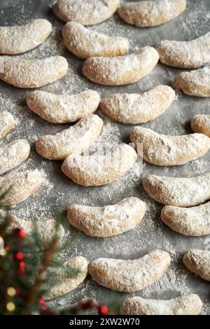 Biscotti di Natale fatti in casa chiamati Kipferl ricoperti di zucchero su carta pergamena Foto Stock