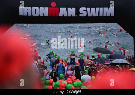 Langen, Germania. 18 agosto 2024. Triathlon: Campionato europeo, Ironman (3,86 km di nuoto, 180 km di bici, 42, 195 km di corsa), uomini. Gli atleti della fascia d'età iniziano a Langener Waldsee per il nuoto. Credito: Arne Dedert/dpa/Alamy Live News credito: dpa Picture Alliance/Alamy Live News Foto Stock