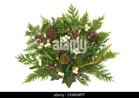 Vegetazione invernale tradizionale con frutti di bosco, edera, abete, pinne su sfondo bianco. Decorazione naturale sempreverde per Yule, Natale, Foto Stock