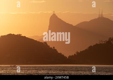 Una vista panoramica del Monte Corcovado contro il cielo crepuscolo sullo sfondo dell'oceano nel centro di Rio de Janeiro, Brasile Foto Stock