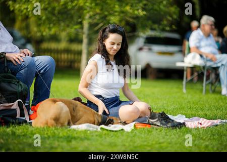 I Burys, Godalming. 18 agosto 2024. Un pomeriggio caldo e soleggiato per le Home Counties. Persone che amano la musica nel parco al Godalming Bandstand nel Surrey. Ogni domenica pomeriggio durante i mesi estivi, viene eseguita musica dal vivo con una varietà di generi. Questo pomeriggio è stato il turno di "The Band of the Surrey Yeomanry", sponsorizzato dalla BL Vision di Farncombe. Crediti: james jagger/Alamy Live News Foto Stock