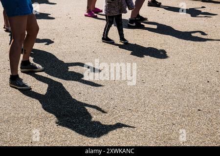 Ombre lanciate da persone che ballano sul Killacourt a Newquay in Cornovaglia nel Regno Unito. Foto Stock