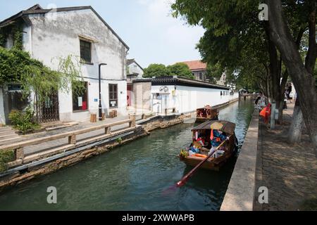 Città di Suzhou, provincia di Jiangsu, Cina - 10 agosto 2024: Una piccola barca di legno che trasporta passeggeri per visite turistiche in Pingjiang Road, Suzhou City, Jiangs Foto Stock