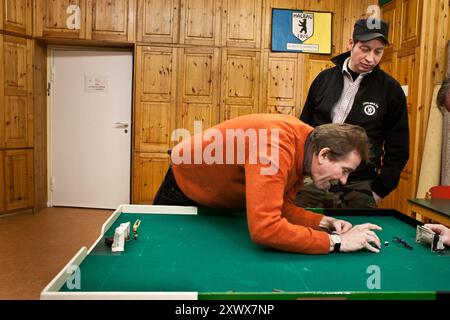 Uomini impegnati in una sessione di allenamento mirata Tipp-Kick presso il club SpVgg Halbau di Berlino, situato a Gemeindehaus Belzstraße 88, Berlino-Lankwitz, nel 2010. La camera con pannelli in legno aggiunge un'atmosfera nostalgica. Foto Stock