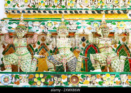 Fantastici dettagli architettonici del Prang principale di Wat Arun con file di mitiche sculture del demone Yaksha e pezzi di porcellana cinese, Bangkok, Thailandese Foto Stock