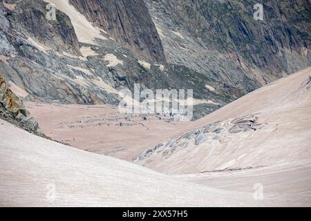 Vista di un ghiacciaio nelle alpi la cui neve è ricoperta di sabbia marrone del sahara Foto Stock