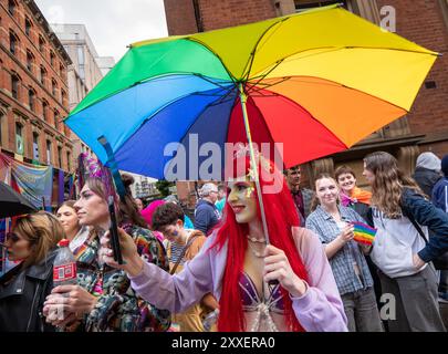 Manchester, UK. 24th Aug, 2024. Palestinian protesters failed to prevent Pride Parade taking place after they blocked road on Peter Street by laying in road. They were objecting against Booking.com who also carry adverts for properties in Israel. The police moved in and cleared the protest allowing the protest to proceed. Some individuals in the parade where carrying Palestinian flags.Manchester Pride 2024 . This year's theme is 'Buzzin To Be Queer - A Hive of Progress' . The symbol of the Manchester Bee led the parade. Credit: GaryRobertsphotography/Alamy Live News Stock Photo