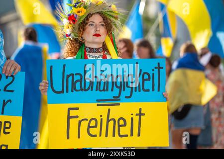 Pro-Ukraine-Kundgebung zum Unabhängigkeitstag am Karlsplatz, Schild Unabhängigkeit gleich Freiheit, München, 24. Agosto 2024 Deutschland, München, 24. 2024 agosto, Pro-Ukraine-Demonstration am Stachus, Frau mit traditionellem ukrainischem Kopfschmuck hält Schild Unabhängigkeit gleich Freiheit, ukrainische Fahnen, Kundgebung unter dem motto: Gemeinsam gegen den Krieg - Ukrainischer Unabhängigkeitstag und 2,5 Jahre der russischen Vollinvasion, veranstaltet von Ukrainern in München, Polilnechus,, 500 *** Pro Ucraina Independence Day Rally a Karlsplatz, segno Foto Stock