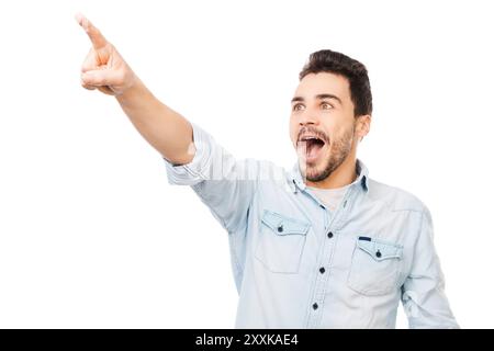Non vedo l'ora di vedere il tuo prodotto. Il giovane sorprese puntando via e sorridendo mentre si trova su sfondo bianco Foto Stock