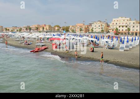 Roma, Italia. 26 agosto 2024. Ombrelloni chiusi e lettini inutilizzati, mentre alcuni bambini giocano sulla costa delle spiagge di Ostia pochi giorni dopo la vacanza di metà agosto a Roma. Massimo Muzzarelli, presidente di Federbalneari e proprietario di Sporting Beach, chiuso dal comune per tasse non pagate, effettua una prima valutazione della stagione balneare che non si è ancora conclusa e segnala un calo di almeno il 40% delle presenze alle spiagge del mare di '' ‹'''‹Roma. Secondo il presidente del Partito Democratico del 10° Municipio, Mario Falconi, il declino non è così drastico e sottolinea che deve essere Foto Stock