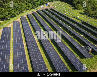 Lunghe file di pannelli solari su un'area verde dal punto di vista aereo, costruzione del parco solare della Foresta Nera, Weil der Stadt, Germania, EUR Foto Stock