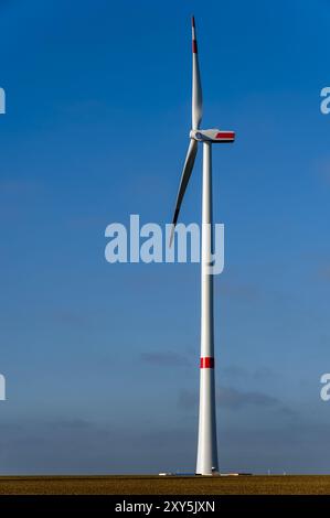 Turbina eolica di recente installazione di fronte a un cielo blu Foto Stock