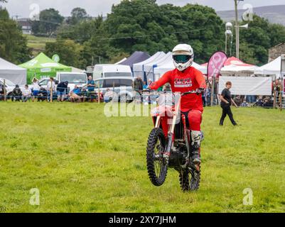 Uno stunt man su una bicicletta da trail al Reeth Show di Swaledale, Yorkshire Dales, Regno Unito. Foto Stock