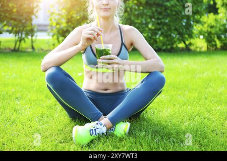 Donna bere tisane a base di erbe dopo l esecuzione di fitness allenamento sul giorno di estate. Fitness e uno stile di vita sano concetto Foto Stock