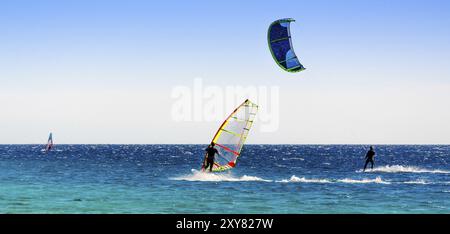 Windsurf e kitesurfer cavalcano nel Mar Rosso in Egitto Dahab Foto Stock